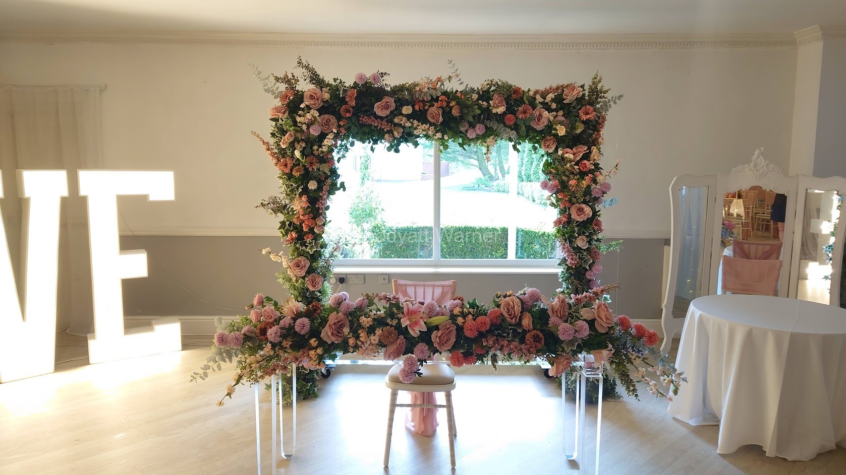 Blush pink floral arch and top table flowers